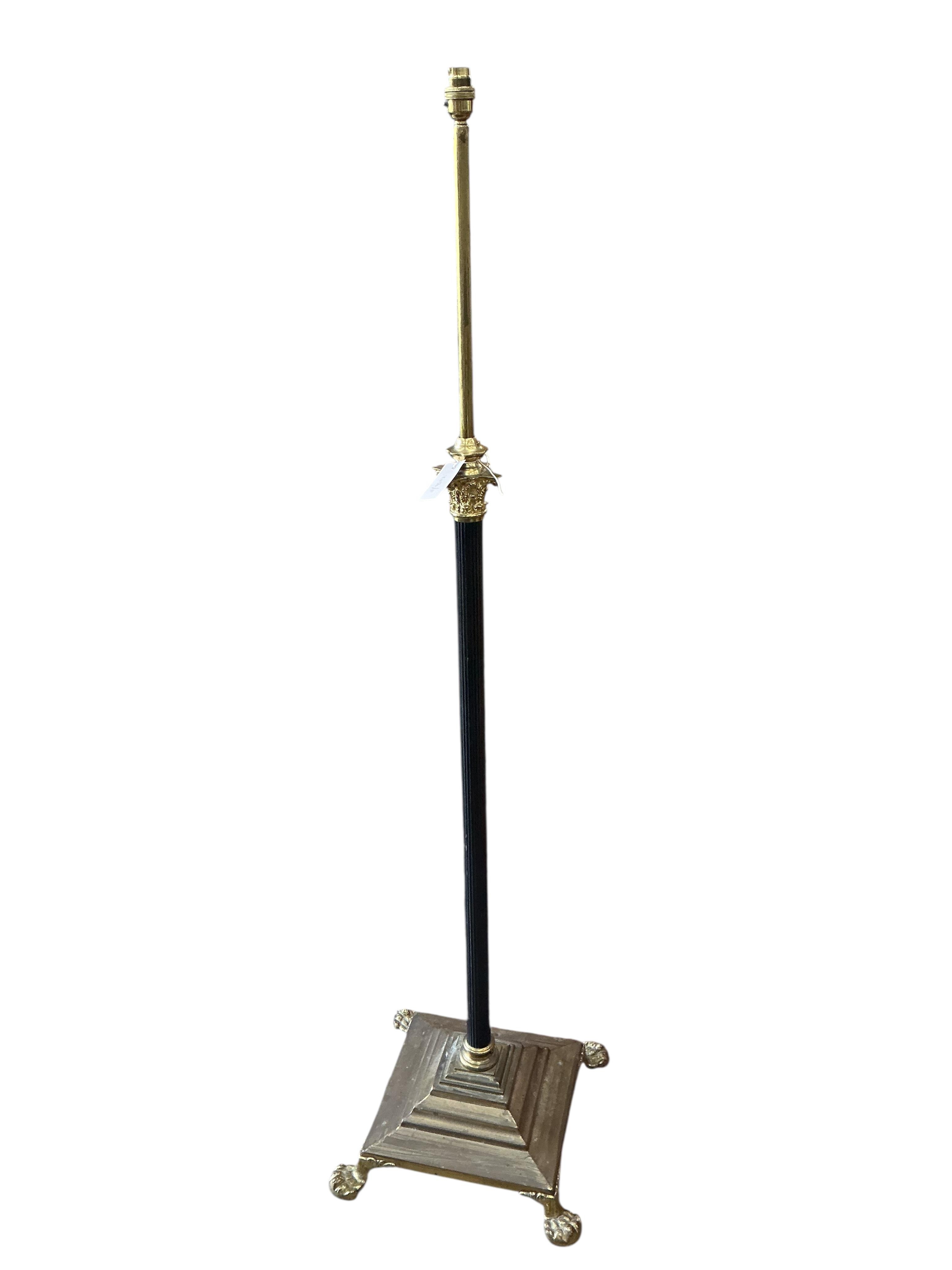 An Edwardian brass telescopic standard lamp on lion's paw feet